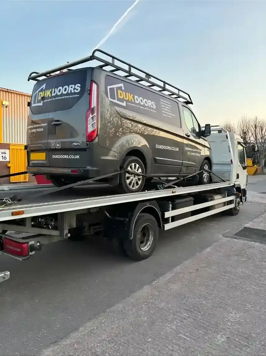 Ford Transit Custom van being recovered on a flatbed towing vehicle. Premier Recoveries provides expert van recovery and commercial vehicle breakdown services across the UK.