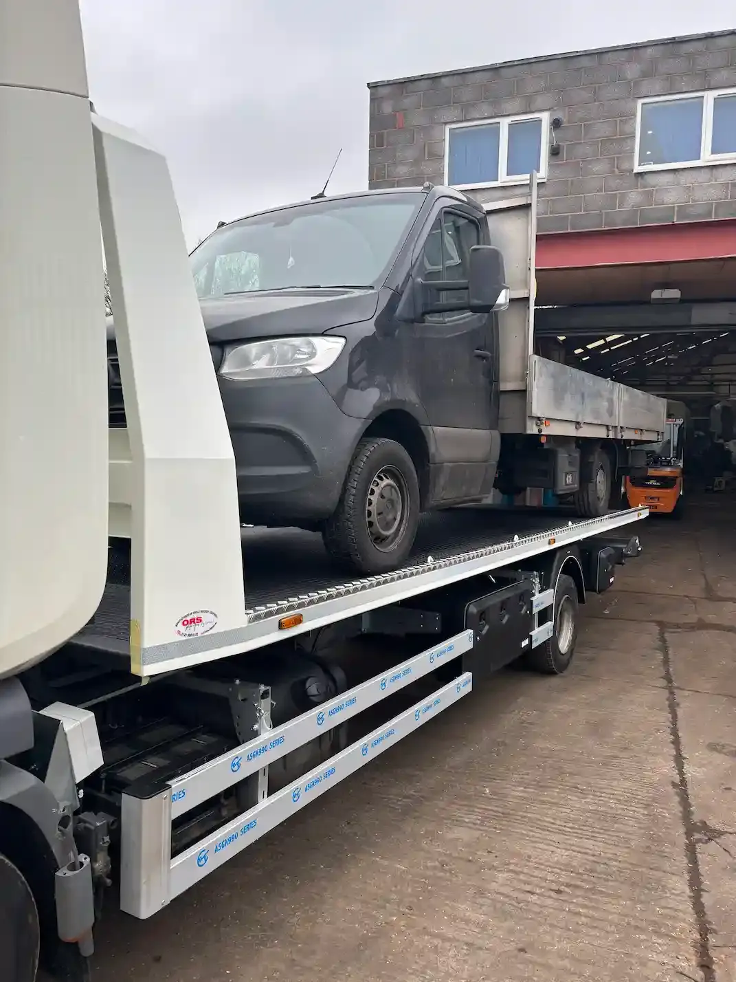 Ford Transit Custom van being recovered on a flatbed towing vehicle. Premier Recoveries provides expert van recovery and commercial vehicle breakdown services across the UK.