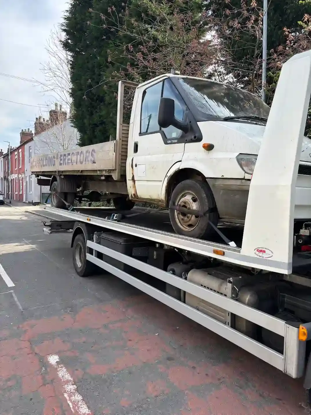 Ford Transit Custom van being recovered on a flatbed towing vehicle. Premier Recoveries provides expert van recovery and commercial vehicle breakdown services across the UK.